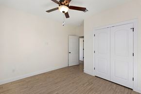 Hondo house for rent - a living room with white walls and a ceiling fan