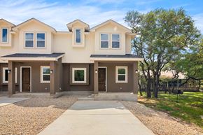 Spring Branch apartment for rent - a beige and brown house with a driveway and trees