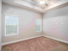 Spring Branch apartment for rent - an empty bedroom with a ceiling fan and two windows