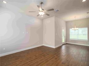 Spring Branch apartment for rent - an empty living room with a ceiling fan and wood floors