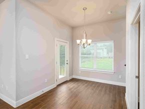 Spring Branch apartment for rent - an empty dining room with hardwood floors and a window