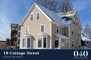Sanford apartment for rent - A house with snow on the roof and a sign that says 18 Cottage Street.