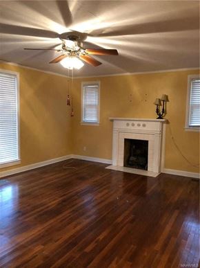 Montgomery house for rent - a living room with a fireplace and a ceiling fan