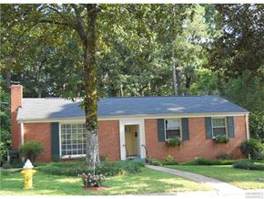 Montgomery house for rent - a small brick house with a yellow fire hydrant in the yard