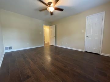 Winston Salem apartment for rent - A room with a ceiling fan and two doors.