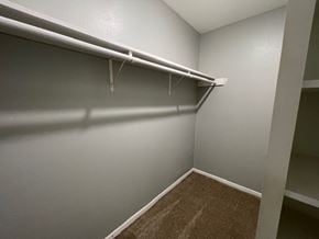 Killeen house for rent - A white closet with a carpeted floor and a white shelf.