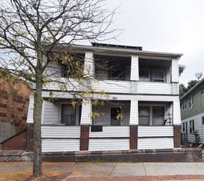 Akron apartment for rent - A white two story house with the number 801 on the front.