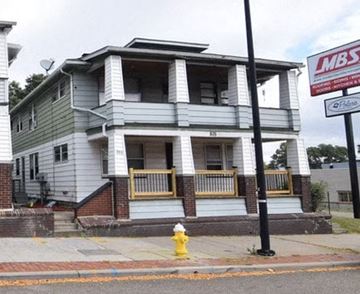 Akron apartment for rent - A two-story house with a sign that says LMBS on the right.