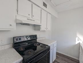 Little Rock apartment for rent - the preserve at ballantyne commons apartment kitchen with stove and white cabinets