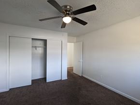 Little Rock apartment for rent - a bedroom with a ceiling fan and a closet