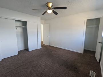 Little Rock apartment for rent - a living room with carpet and a ceiling fan