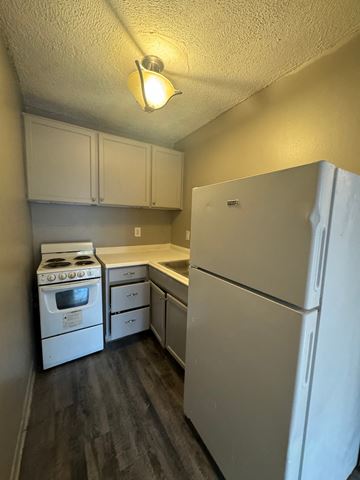 Little Rock apartment for rent - a kitchen with white appliances and a refrigerator