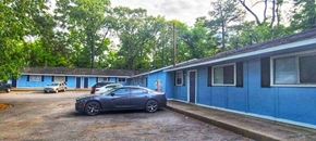 Little Rock apartment for rent - a car parked in front of a blue building