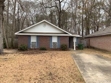 Montgomery house for rent - A house with a white roof and a driveway in front.