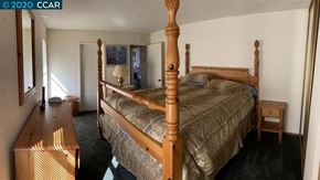 Bay Point apartment for rent - a bedroom with a large bed and a dresser