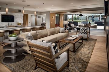 San Diego apartment for rent - A modern living room with a large couch and a television.