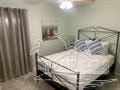 Gulf Breeze house for rent - a bedroom with a bed and a window and a curtain
