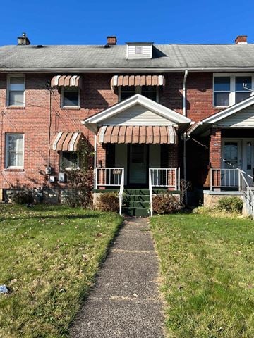 Clairton house for rent - an old brick house with a sidewalk in front of it