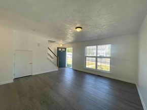 Winchester townhouse for rent - A room with a staircase and a window overlooking a street.