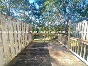 Winchester townhouse for rent - a wooden deck with trees in the background