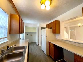 Winchester townhouse for rent - a kitchen with wooden cabinets and a sink and a refrigerator