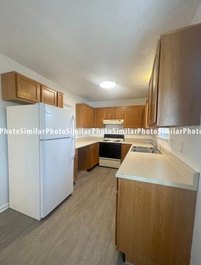 Winchester townhouse for rent - a kitchen with white appliances and wooden cabinets