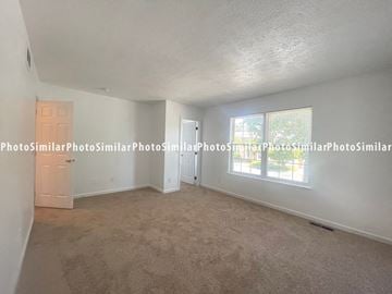 Winchester townhouse for rent - the living room of the 2400 sqft home has a large window and carpet