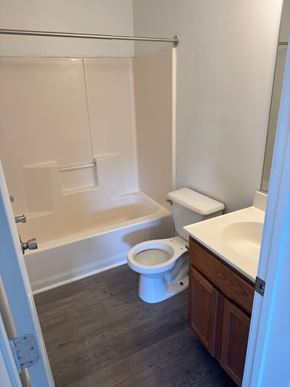 Winchester townhouse for rent - A white toilet sits in a bathroom next to a sink.