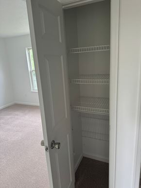 Winchester townhouse for rent - A white door is open to a room with a carpeted floor.