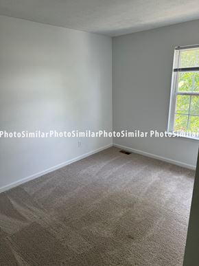 Winchester townhouse for rent - a bedroom with a large window and a carpeted floor