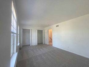 Winchester townhouse for rent - an empty living room with white walls and carpet