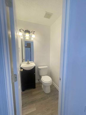 Winchester townhouse for rent - a bathroom with a toilet and a sink and a mirror