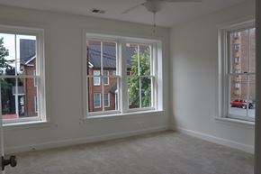 Winchester apartment for rent - A room with three windows and a ceiling fan.