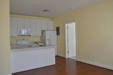 Winchester apartment for rent - A kitchen with white cabinets and a white refrigerator.