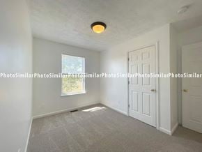 Winchester townhouse for rent - A room with a carpeted floor, a window, and a door.