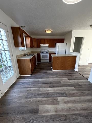 Winchester townhouse for rent - A kitchen with wooden cabinets and a white refrigerator.