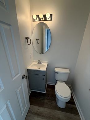Winchester townhouse for rent - A white toilet sits next to a sink in a small bathroom.