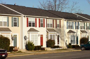 Winchester townhouse for rent - A row of houses with different colored front doors.