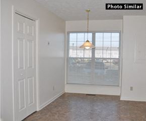 Winchester townhouse for rent - A room with a white door and a window with a lamp hanging from the ceiling.