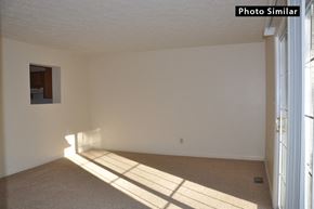 Winchester townhouse for rent - A sunlit room with a carpeted floor and a window on the right side.