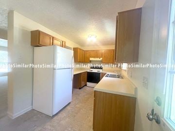 Winchester townhouse for rent - a kitchen with white appliances and wooden cabinets