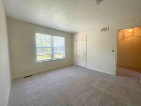 Winchester townhouse for rent - A room with a carpeted floor, a window, and a door.