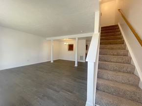 Winchester townhouse for rent - the upstairs living room and dining room with carpeted stairs and white walls