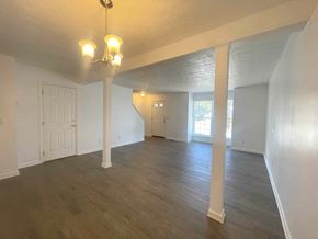 Winchester townhouse for rent - an empty living room with white walls and a wood floor
