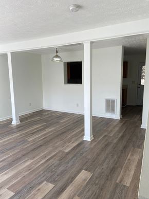 Winchester townhouse for rent - A room with wooden floors and white walls.