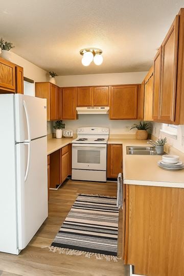 Winchester townhouse for rent - A kitchen with wooden cabinets and a white refrigerator.