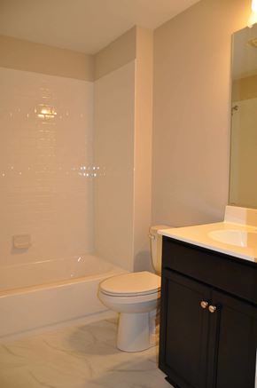 Winchester apartment for rent - A white toilet sits next to a bathtub in a bathroom.