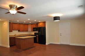 Winchester apartment for rent - A kitchen with a black refrigerator and wooden cabinets.