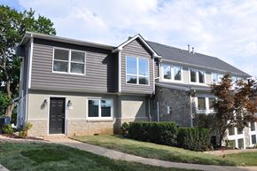Winchester apartment for rent - A house with a grey siding and a black door.