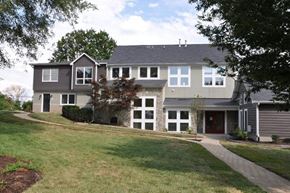 Winchester apartment for rent - A grey house with a red door and white windows.